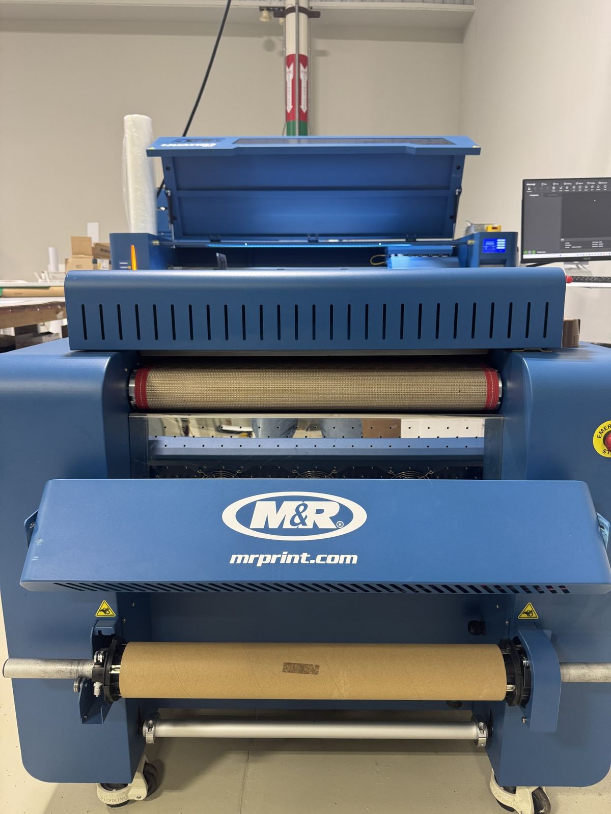 The M&R DTF transfer printer on the production floor at ATS Printing